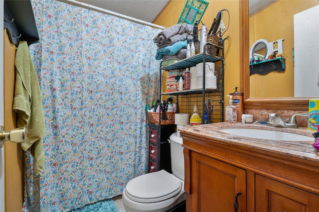 full bathroom with vanity, toilet, and a textured ceiling