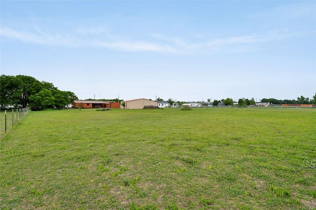 view of yard with a rural view and fence