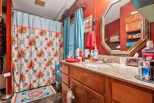 bathroom featuring curtained shower, visible vents, and vanity