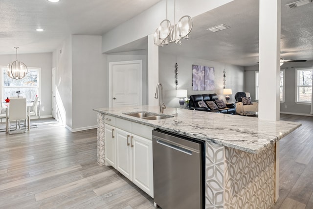 kitchen featuring a sink, white cabinetry, dishwasher, and an island with sink