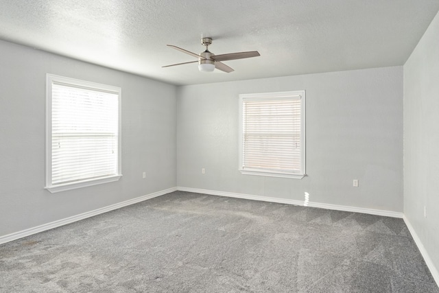 spare room with baseboards, a textured ceiling, a ceiling fan, and carpet flooring