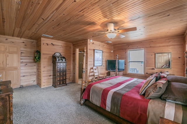 carpeted bedroom with wooden ceiling, wood walls, and ceiling fan