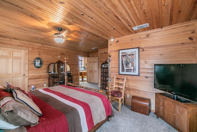 bedroom with wood ceiling, wood walls, carpet, and visible vents