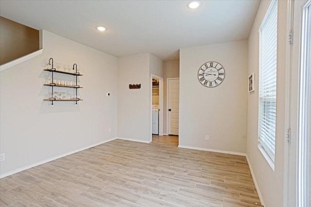 spare room with light wood finished floors, baseboards, and recessed lighting