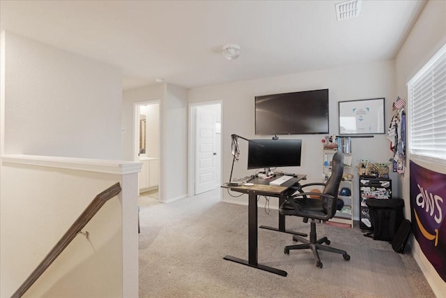 office area featuring visible vents and light colored carpet