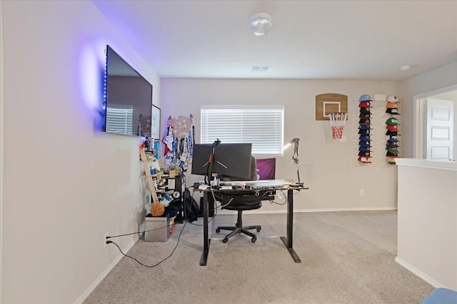 office featuring baseboards, visible vents, and light colored carpet