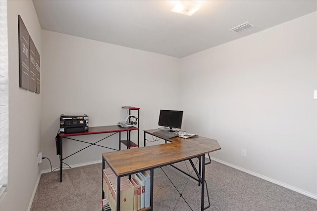 office space featuring light carpet, visible vents, and baseboards