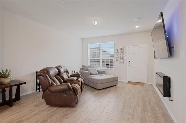 living room featuring light wood-style floors and baseboards