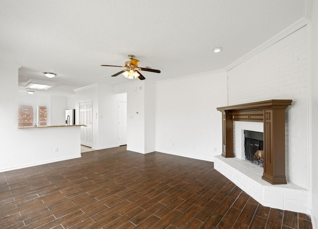 unfurnished living room featuring dark wood-style flooring, a fireplace, ornamental molding, ceiling fan, and baseboards