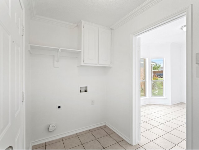 laundry room featuring light tile patterned flooring, hookup for a washing machine, cabinet space, electric dryer hookup, and crown molding