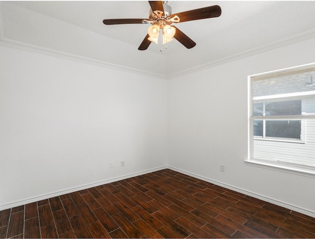 empty room featuring crown molding, baseboards, ceiling fan, and dark wood-style flooring