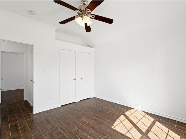 unfurnished bedroom with a ceiling fan, wood tiled floor, crown molding, and baseboards