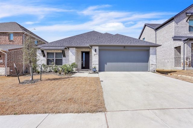 view of front of house with a garage, concrete driveway, a shingled roof, and stone siding