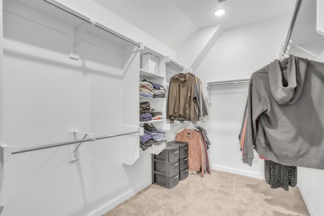 spacious closet featuring light carpet and vaulted ceiling