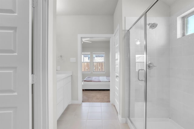 full bathroom with a wealth of natural light, a shower stall, and tile patterned floors