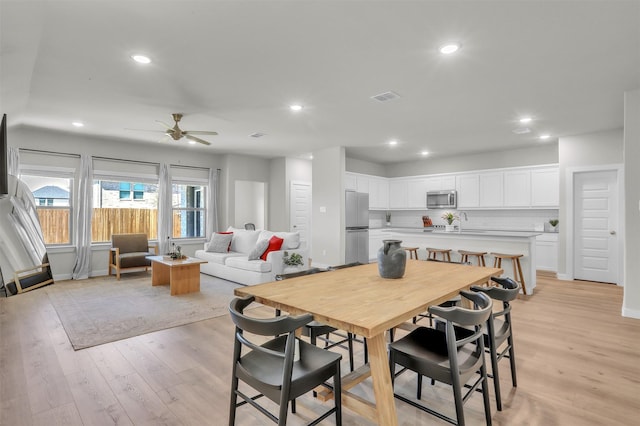 dining space with ceiling fan, light wood finished floors, visible vents, and recessed lighting