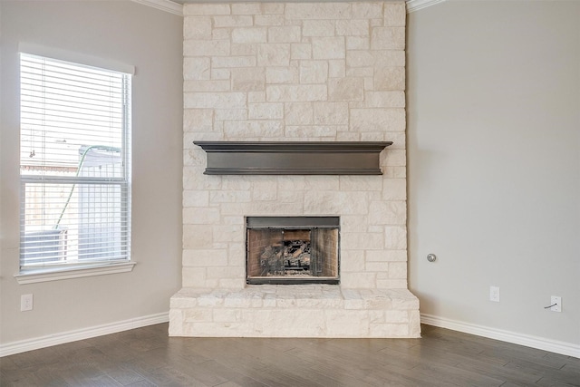 interior details with a fireplace, baseboards, and wood finished floors