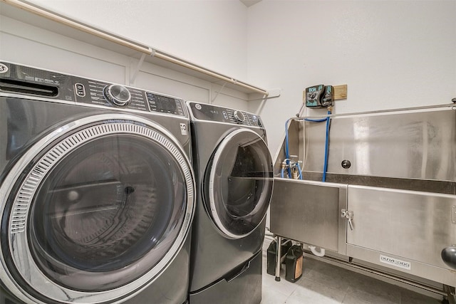 washroom with laundry area, independent washer and dryer, and tile patterned floors