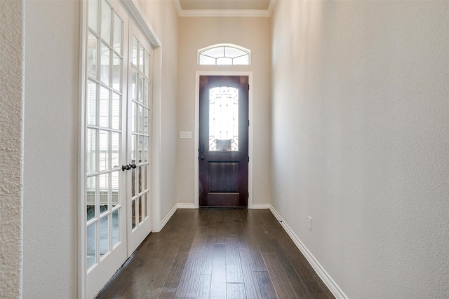 entrance foyer featuring dark wood-type flooring, french doors, ornamental molding, and baseboards