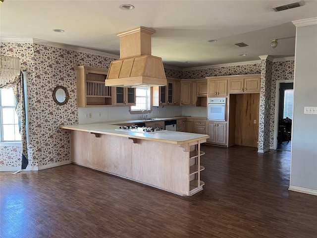 kitchen with glass insert cabinets, a breakfast bar area, a peninsula, light countertops, and open shelves