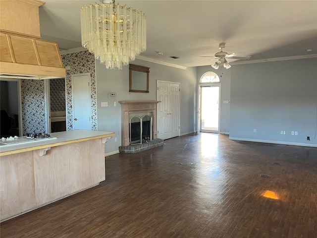 kitchen with a fireplace, light countertops, ornamental molding, white gas cooktop, and open floor plan