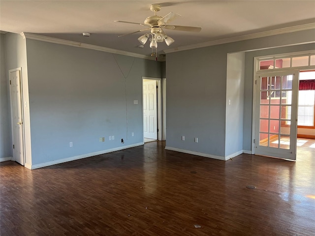 empty room with baseboards, dark wood finished floors, a ceiling fan, and crown molding