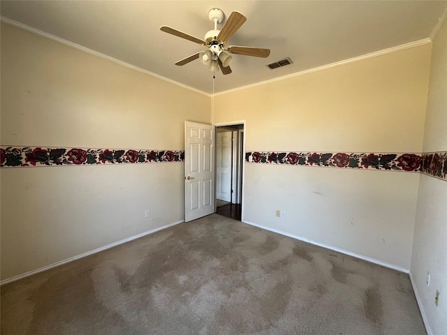 spare room featuring ornamental molding, carpet, visible vents, and baseboards