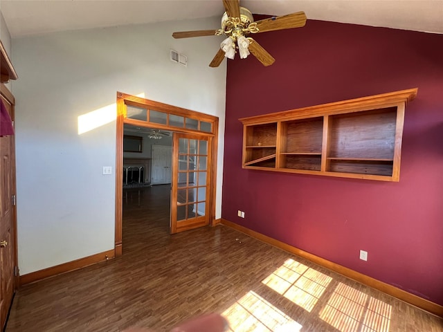 unfurnished room with dark wood-type flooring, visible vents, ceiling fan, and baseboards