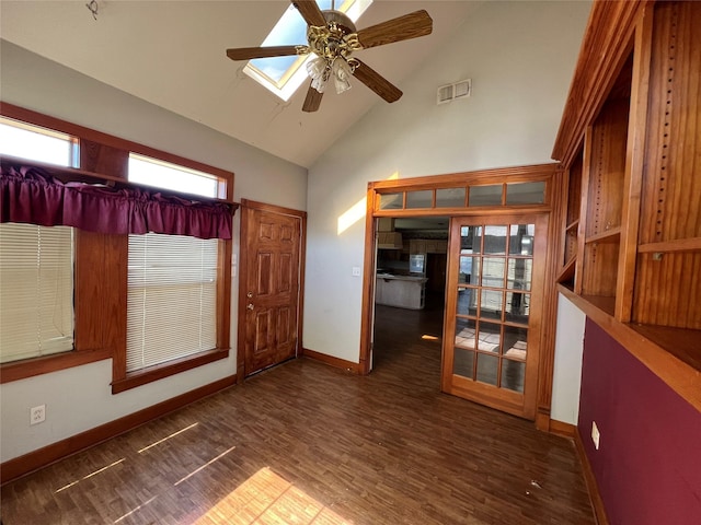 spare room with baseboards, visible vents, a ceiling fan, dark wood-style flooring, and high vaulted ceiling