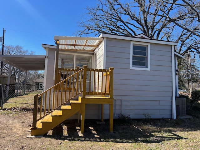 view of outbuilding featuring central AC and fence