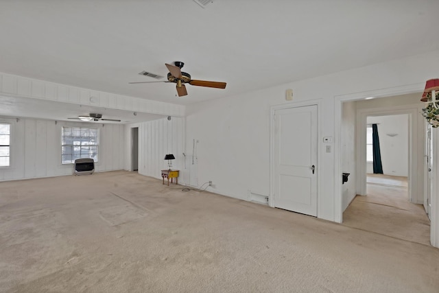 unfurnished living room with ceiling fan, visible vents, and light colored carpet