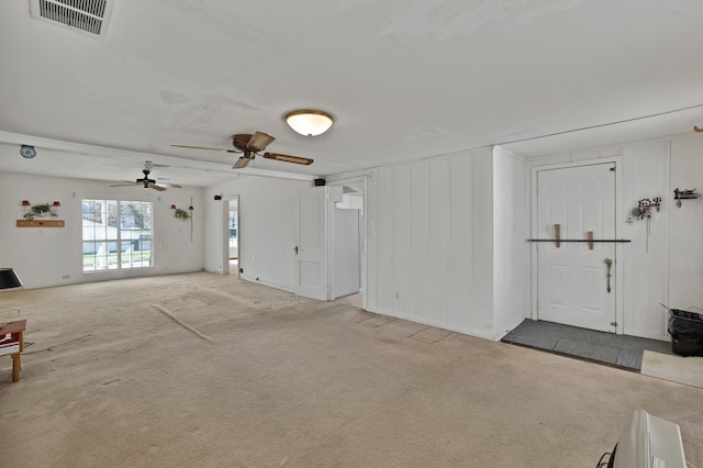 unfurnished living room with carpet floors and visible vents