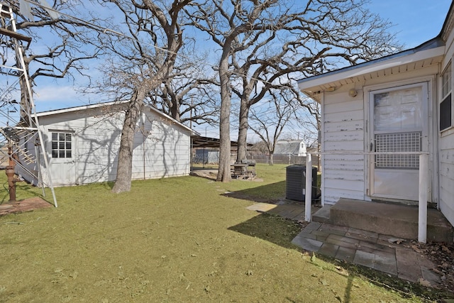 view of yard with fence and central air condition unit