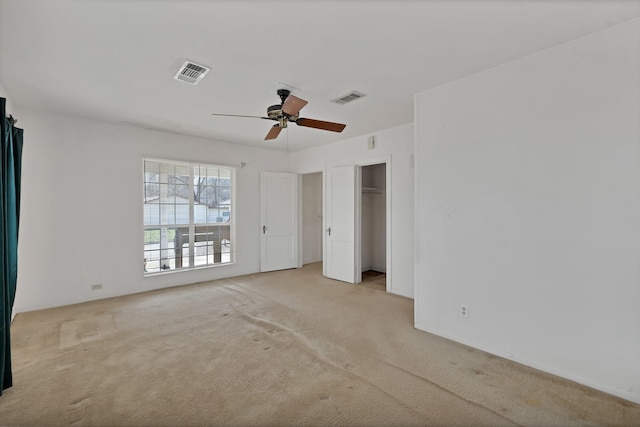 unfurnished bedroom with a ceiling fan, visible vents, and carpet flooring