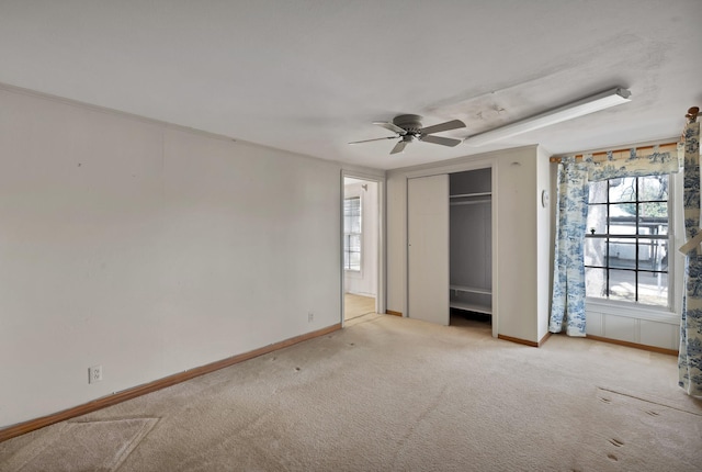 unfurnished bedroom featuring a closet, carpet flooring, ceiling fan, and baseboards