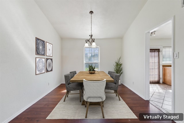 dining room with dark wood-type flooring, a wealth of natural light, and baseboards