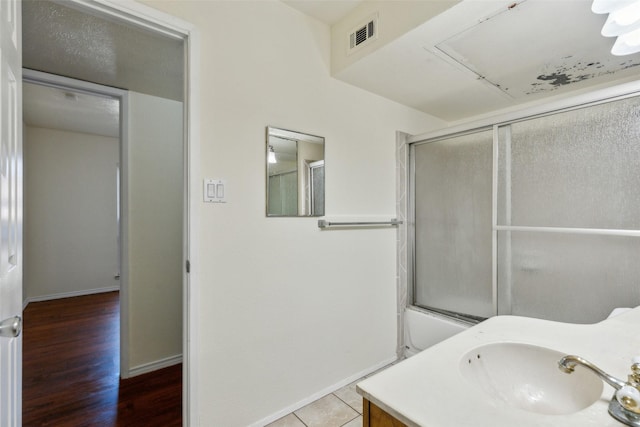 bathroom with baseboards, visible vents, wood finished floors, and vanity