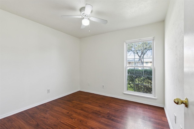 empty room with a wealth of natural light, baseboards, and wood finished floors