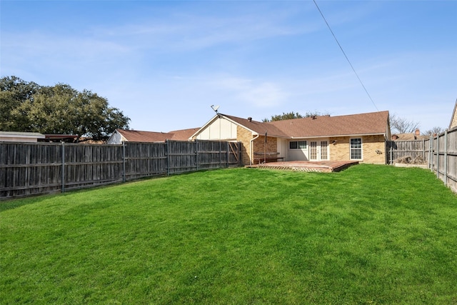 view of yard with a patio area, a fenced backyard, and french doors