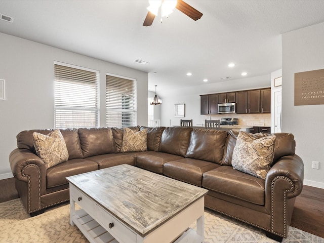 living room featuring baseboards, visible vents, a ceiling fan, light wood-style floors, and recessed lighting