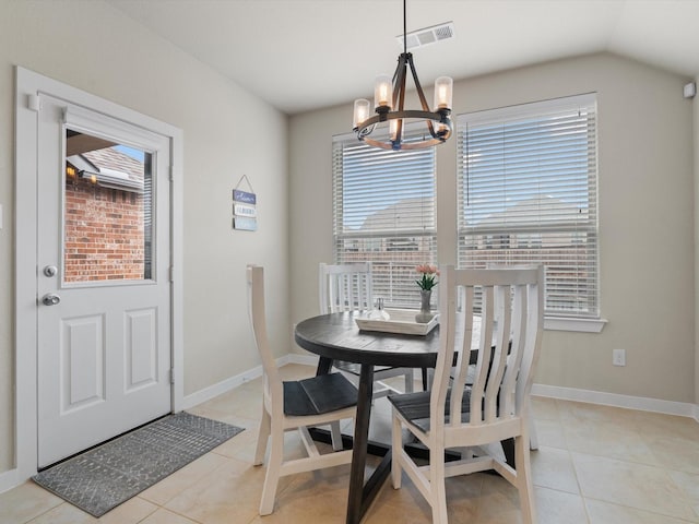 dining room with light tile patterned floors, baseboards, visible vents, and a chandelier