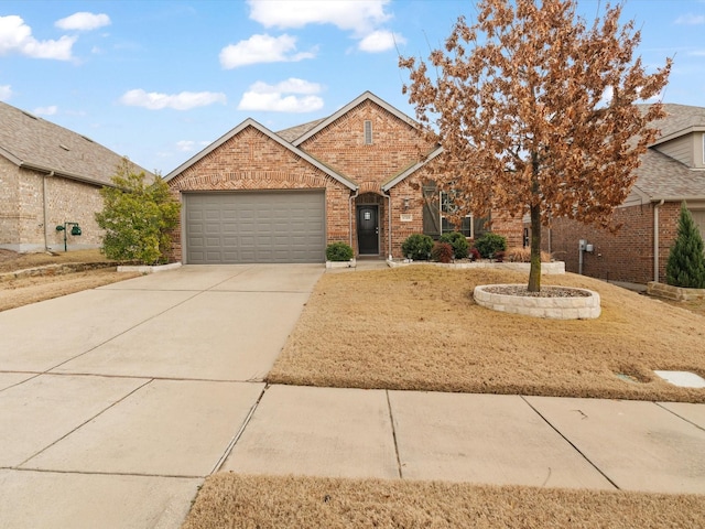 view of front of property featuring a garage, brick siding, and driveway