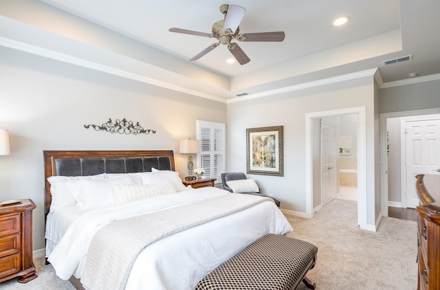 bedroom with light colored carpet, a raised ceiling, visible vents, and baseboards