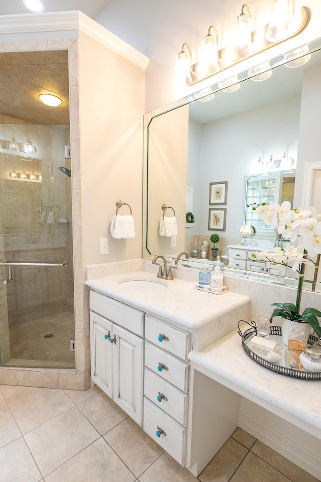 full bath with a stall shower, tile patterned flooring, and vanity