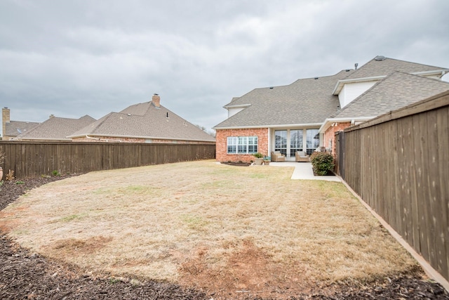 view of yard with a patio and a fenced backyard