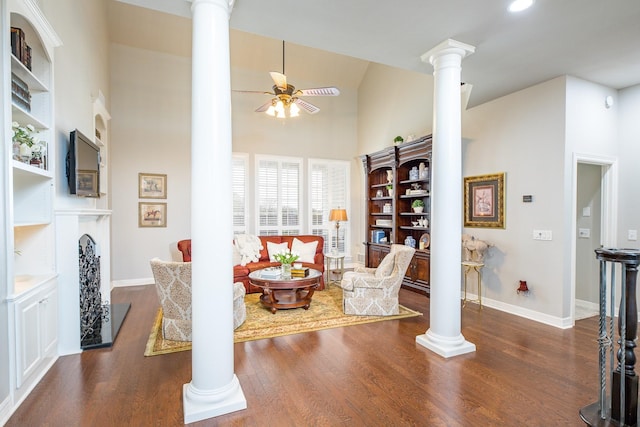 living area with ornate columns and dark wood-style floors