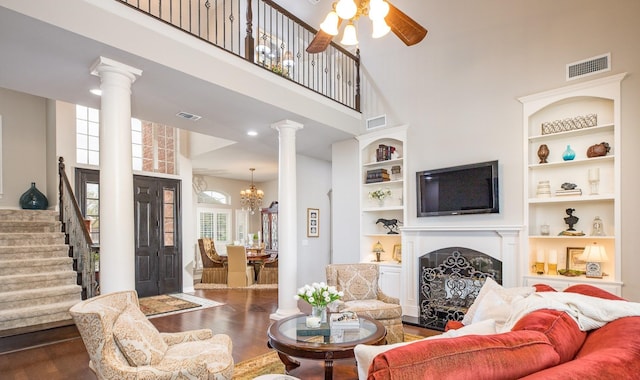 living room featuring dark wood-type flooring, visible vents, and plenty of natural light