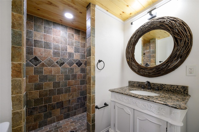 full bathroom featuring tiled shower, wooden ceiling, vanity, and recessed lighting