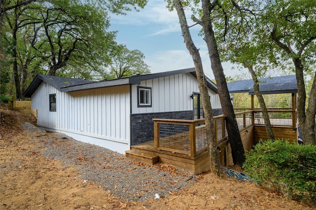 view of home's exterior with board and batten siding and stone siding