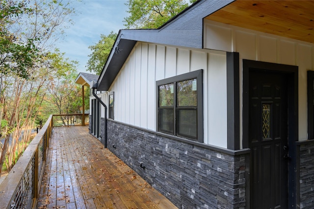 view of side of home featuring stone siding and board and batten siding